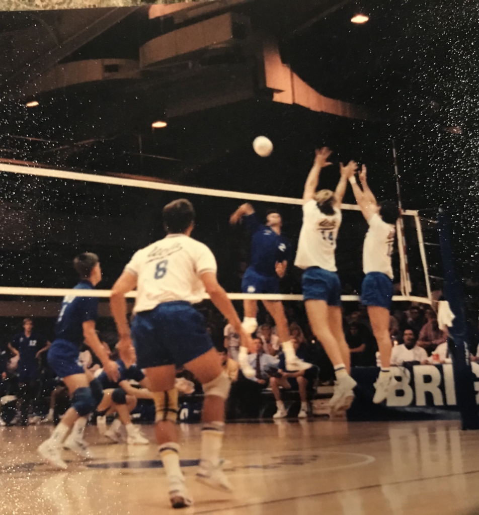 Image of Warren playing volleyball in college